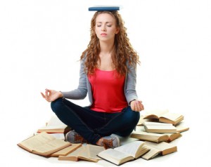 student girl sitting and meditating with books